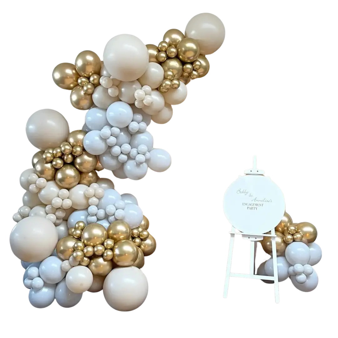 Gold and pearl balloon garland around a gold sequin engagement feature wall with a personalised easel sign