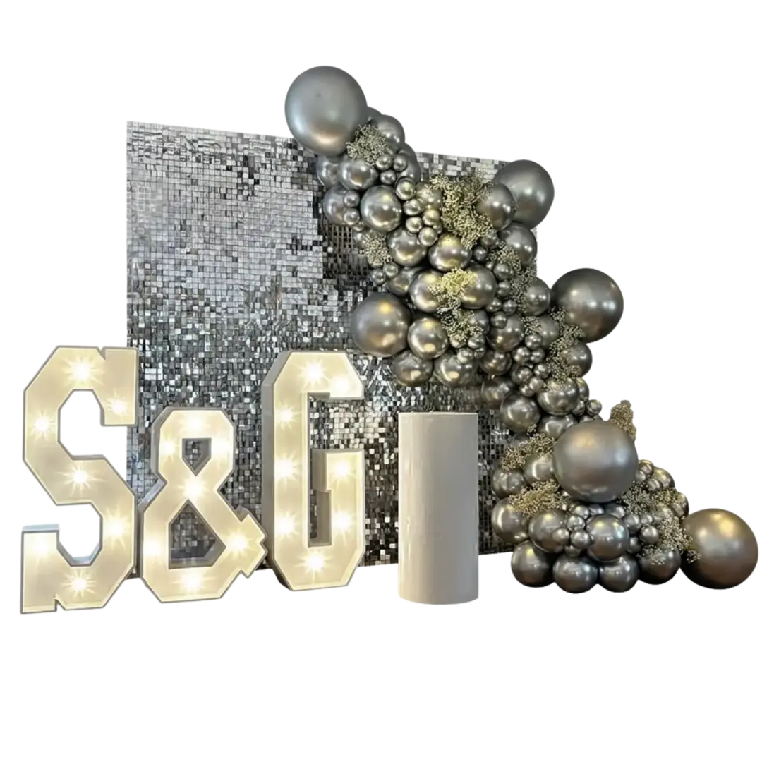 Silver sequin feature wall with metallic balloon garland and illuminated S and J letters