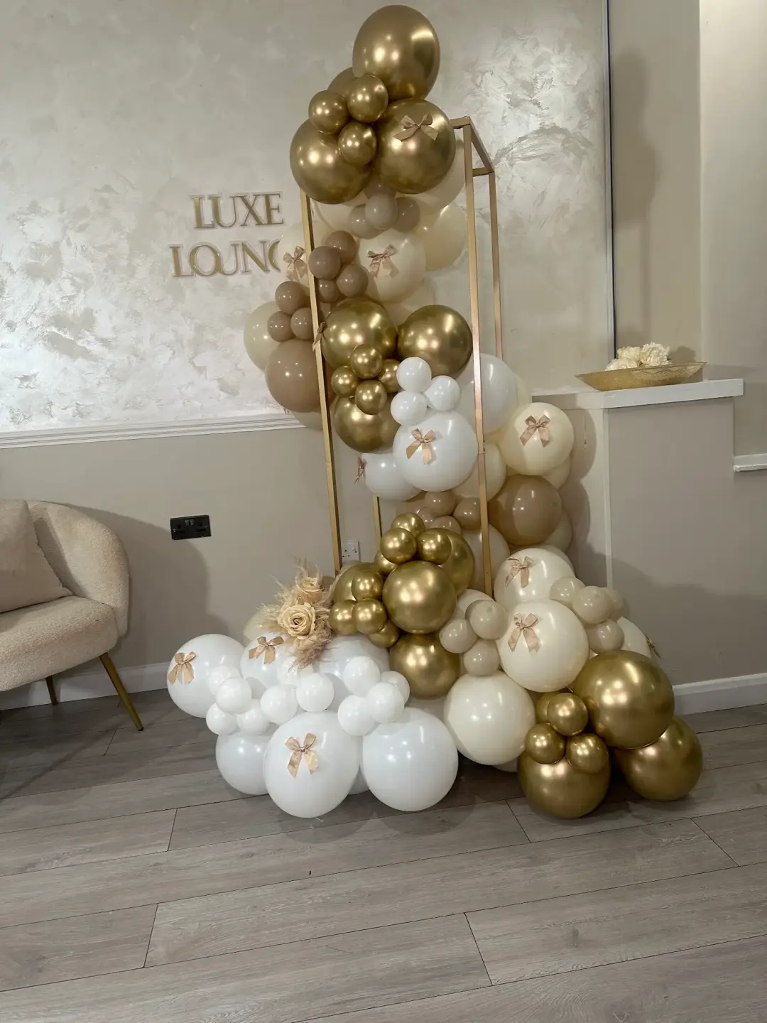 Cream and gold balloon display with satin bows