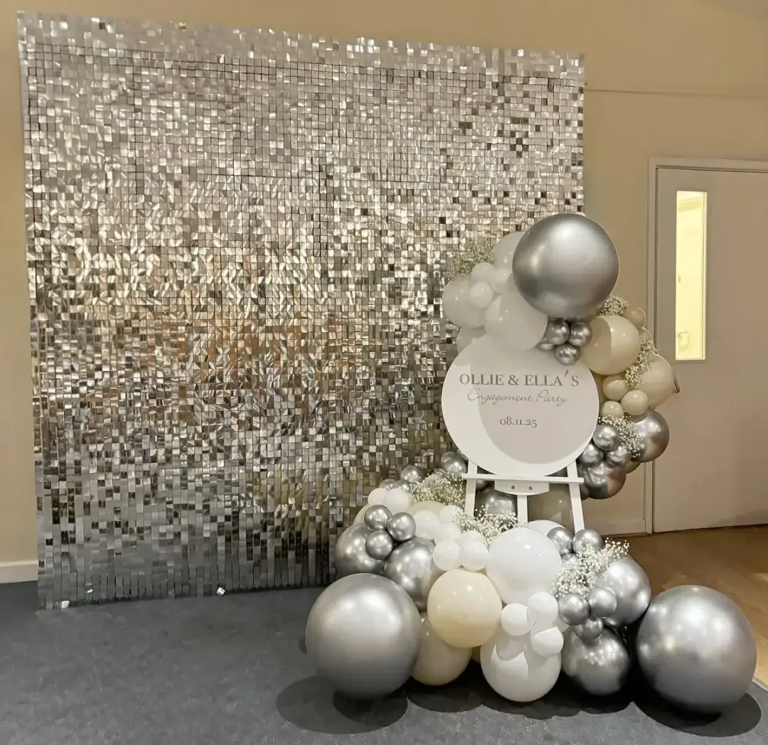 Silver sequin wall with white and silver balloons